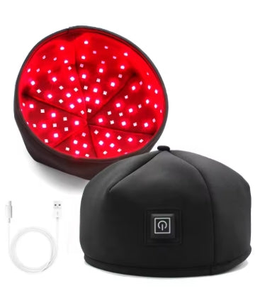 A black LED light therapy head cap with red illuminated LEDs on the inside, alongside a USB cable.