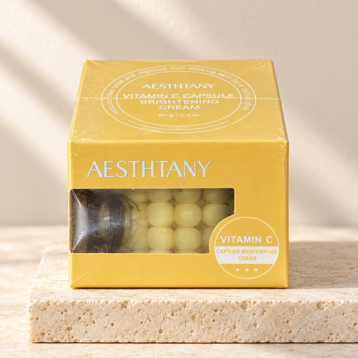 AESTHTANY Vitamin C Capsule Brightening Cream 65 g on stone pedestal